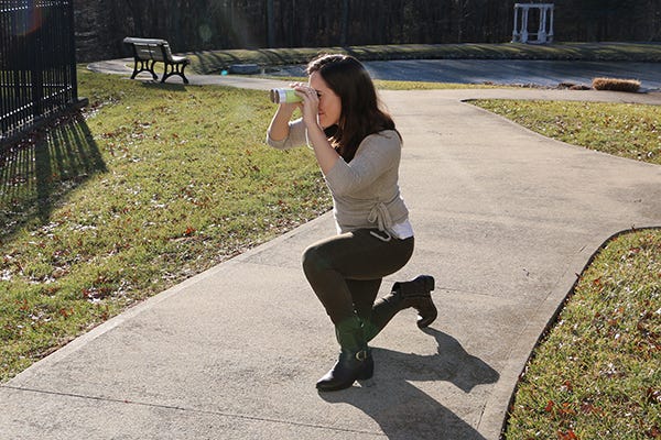 person looking through binoculars