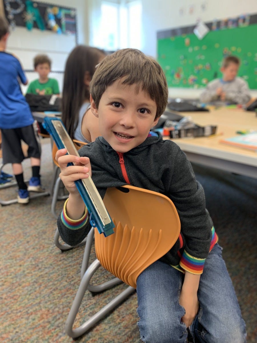 student holding hole punch