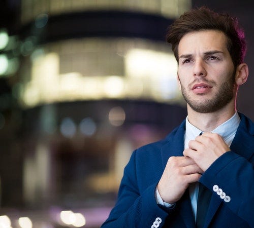 man fixing tie