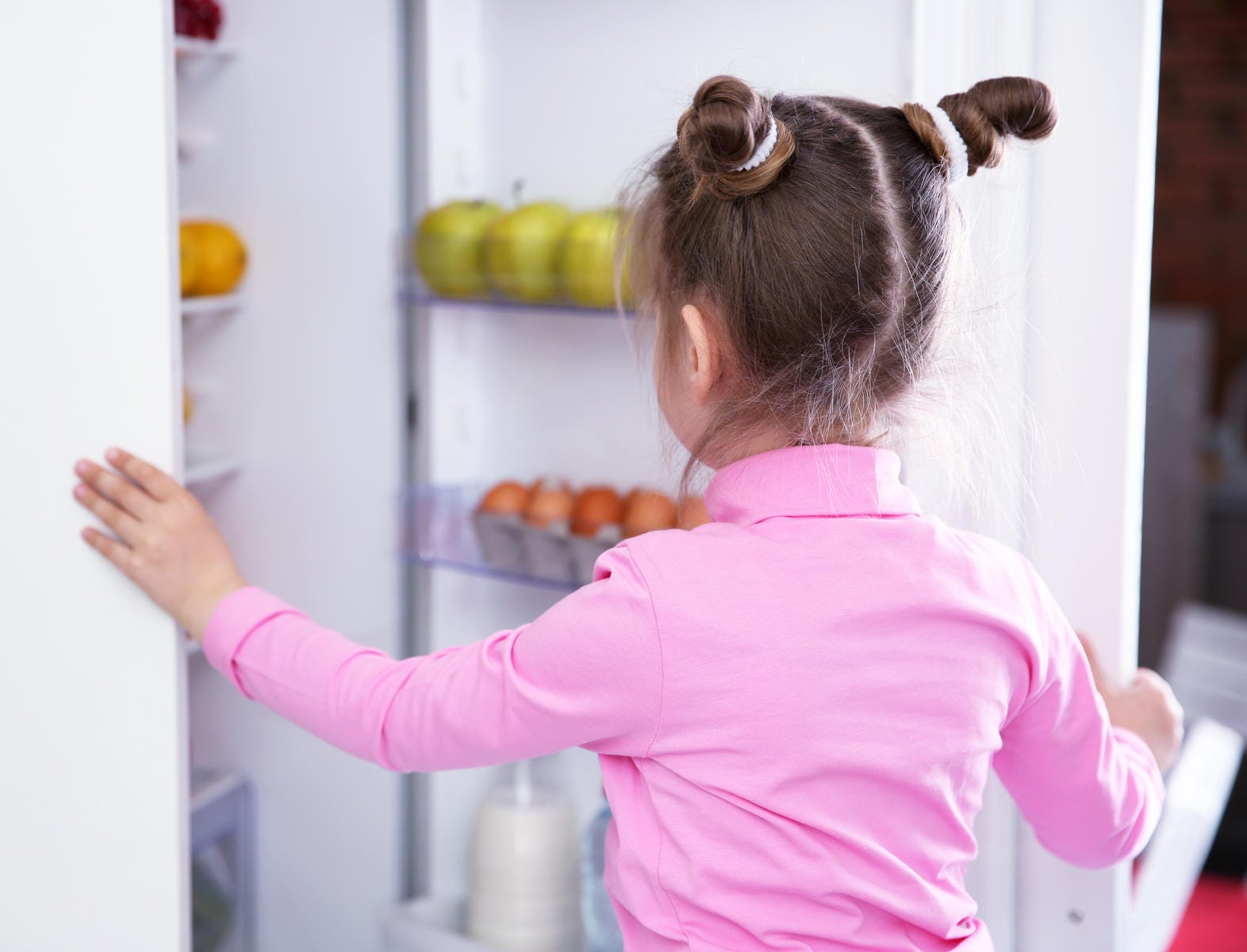 kid looking in fridge